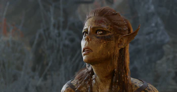 Lae'zel, is out of breath after being bested by the player character from her challenge to prove worthy of her affections in combat. She has a look of awe and exhaustion on her face.