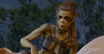 A picture of Lae'zel at camp. She has roused the player character from sleep at their bedside, and is looking at them with anticipation, as she eagerly awaits another night with them.